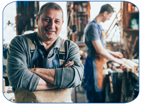 male woodworker crossed arms smiling at camera